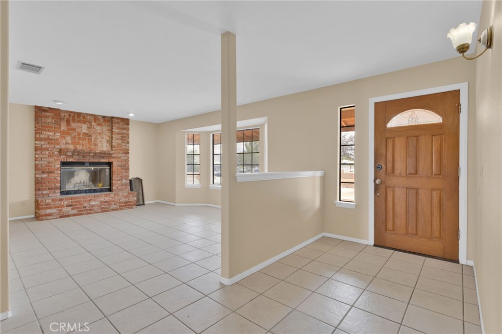 15160 Cheyenne Road Apple Valley, CA 92307 - Photo 3 of 55 a view of a livingroom with an empty space and a fireplace