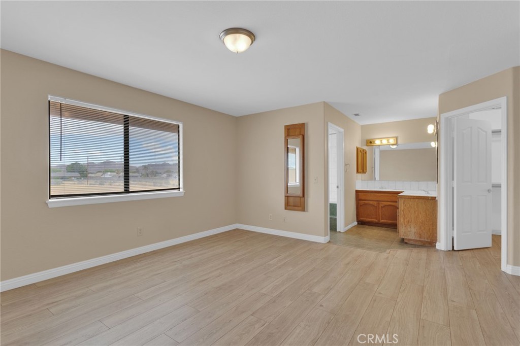 15160 Cheyenne Road Apple Valley, CA 92307 - Photo 31 of 55 a view of a big room with wooden floor and a window