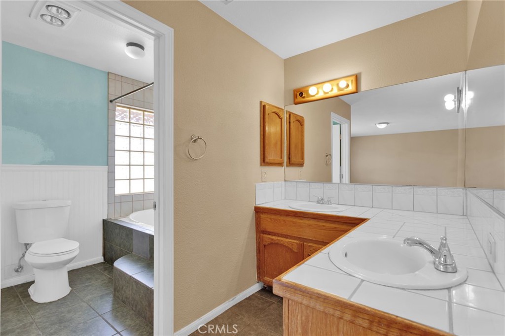 15160 Cheyenne Road Apple Valley, CA 92307 - Photo 33 of 55 a bathroom with a sink a toilet and shower