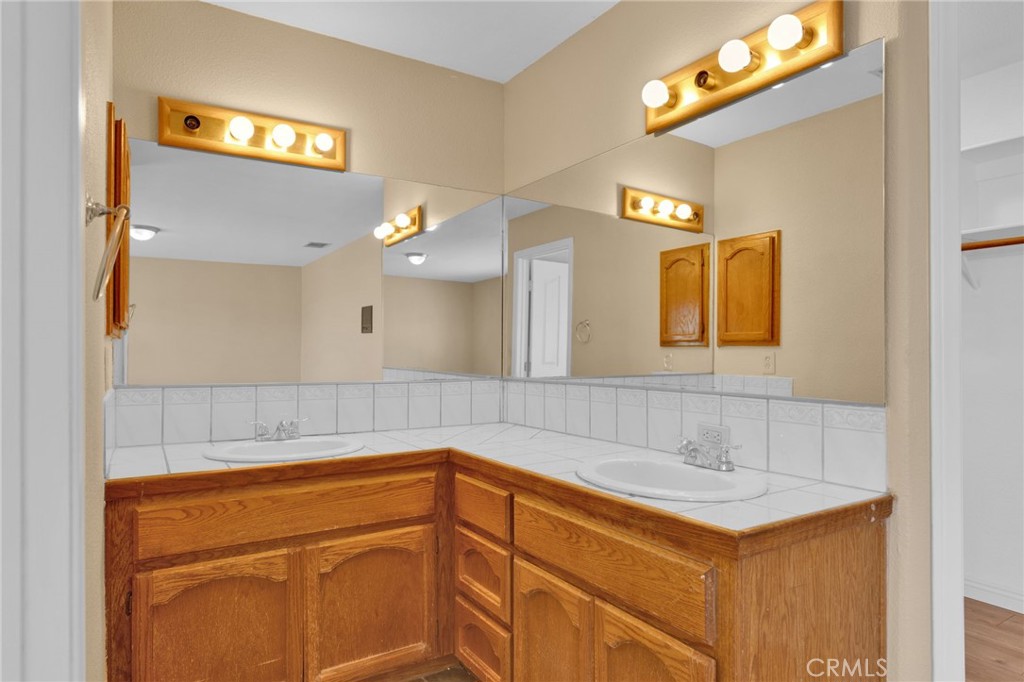 15160 Cheyenne Road Apple Valley, CA 92307 - Photo 35 of 55 a bathroom with a sink and a mirror