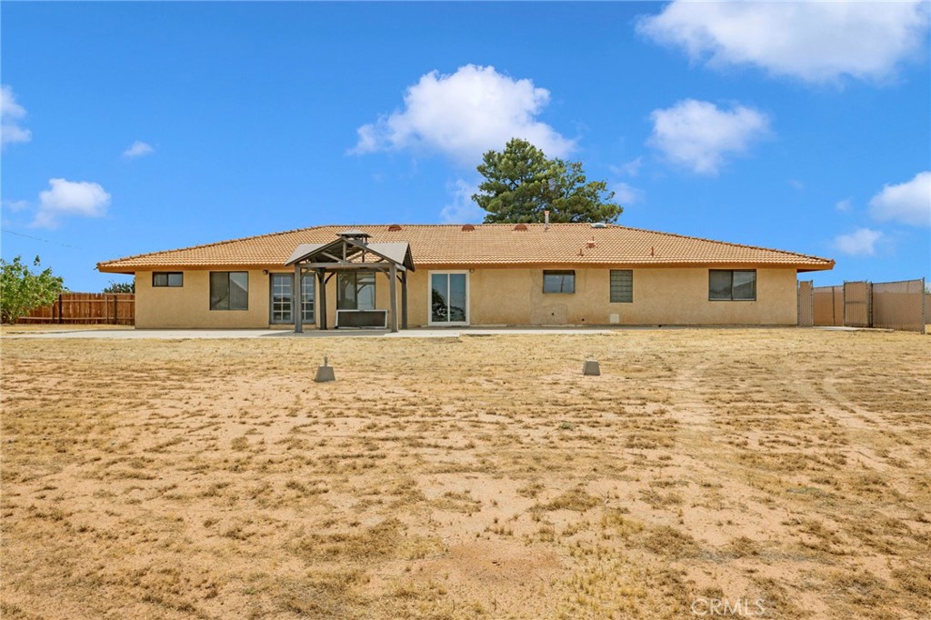 15160 Cheyenne Road Apple Valley, CA 92307 - Photo 42 of 55 a front view of a house with a yard