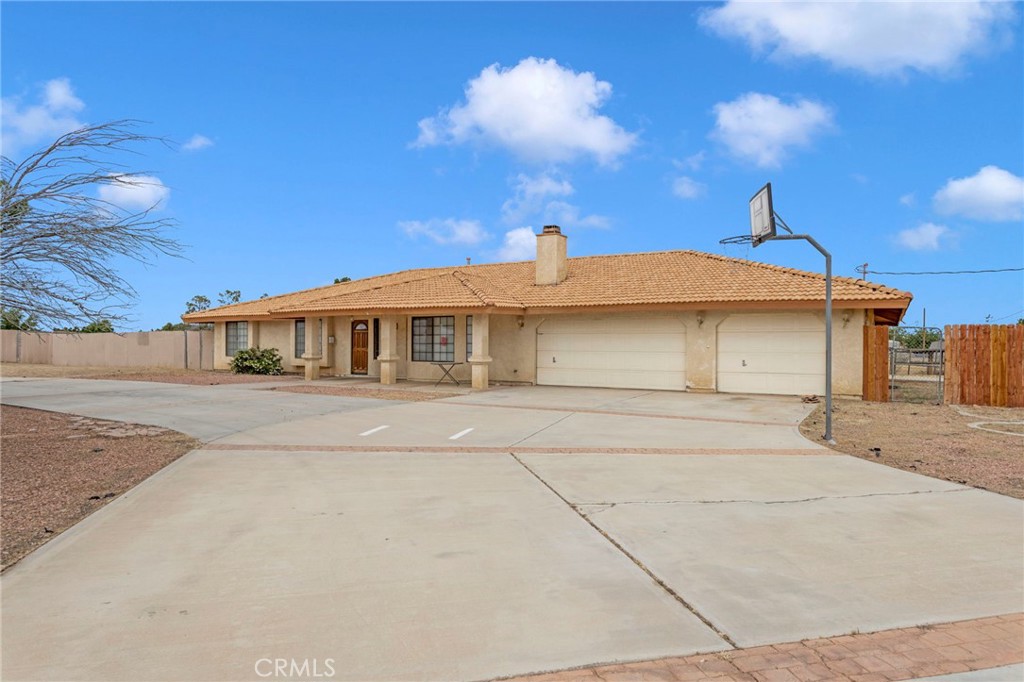 15160 Cheyenne Road Apple Valley, CA 92307 - Photo 55 of 55 a front view of a house with a yard