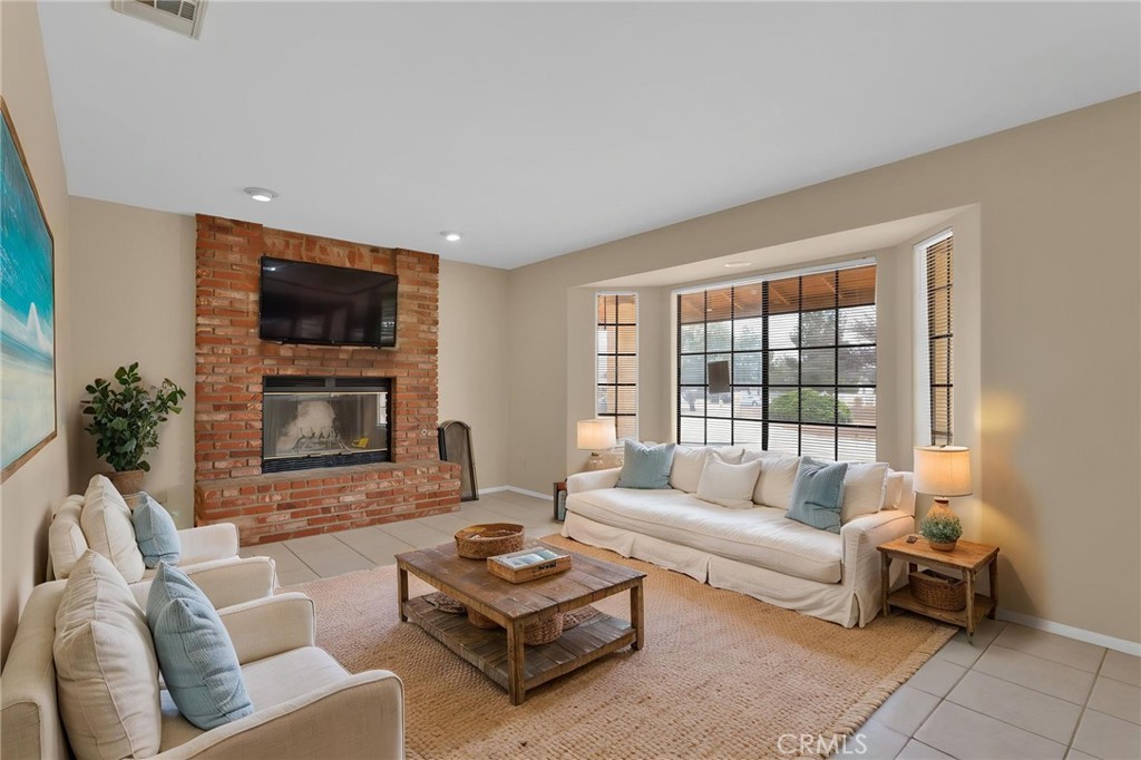 15160 Cheyenne Road Apple Valley, CA 92307 - Photo 6 of 55 a living room with furniture a flat screen tv and a large window