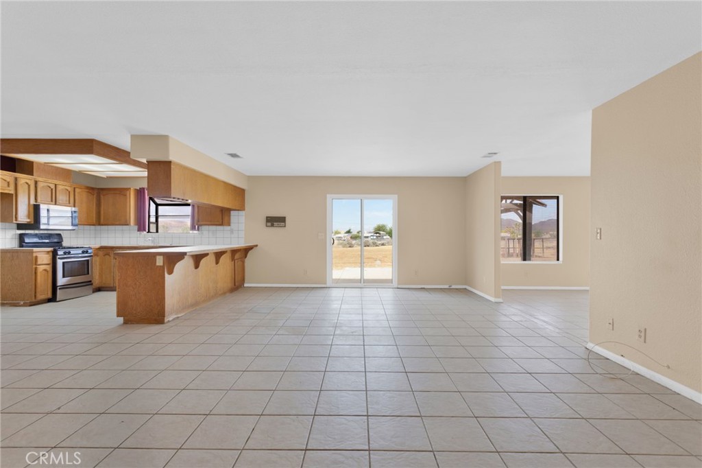 15160 Cheyenne Road Apple Valley, CA 92307 - Photo 8 of 55 a large white kitchen with a stove a sink dishwasher and a refrigerator