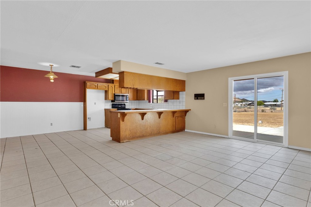 15160 Cheyenne Road Apple Valley, CA 92307 - Photo 9 of 55 a kitchen with stainless steel appliances a sink and cabinets