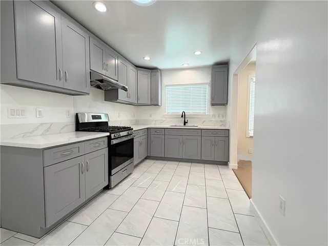 a kitchen with stainless steel appliances granite countertop a sink and cabinets