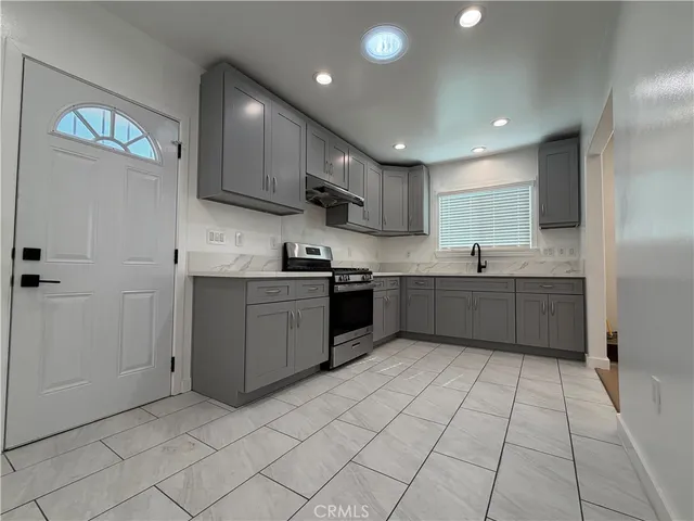 a kitchen with stainless steel appliances granite countertop a sink and cabinets