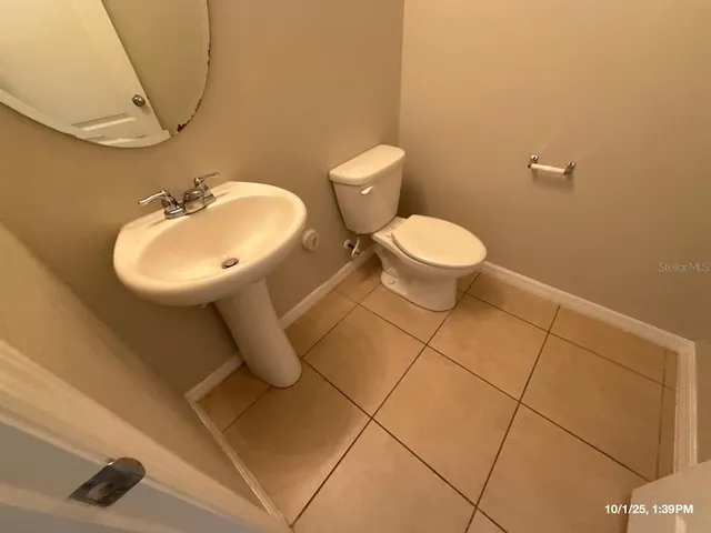 a bathroom with a sink toilet and a mirror