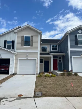 a view of a white house with large windows