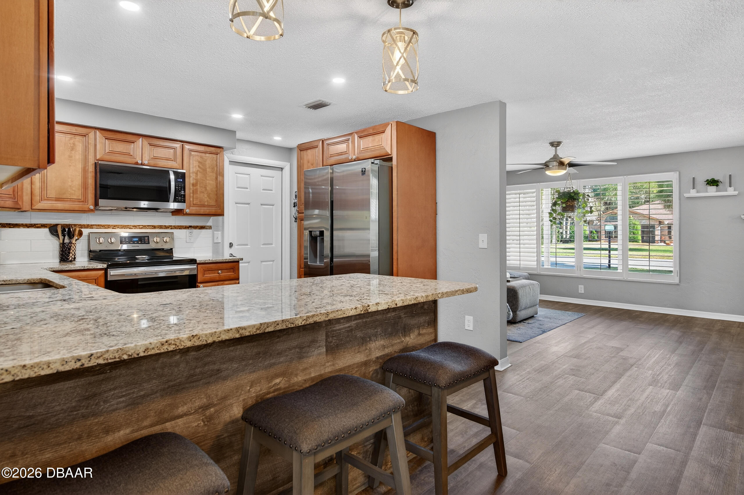1010 Fernald Street Edgewater, FL 32132 - Photo 12 of 43 a kitchen with stainless steel appliances granite countertop a sink a stove and a refrigerator