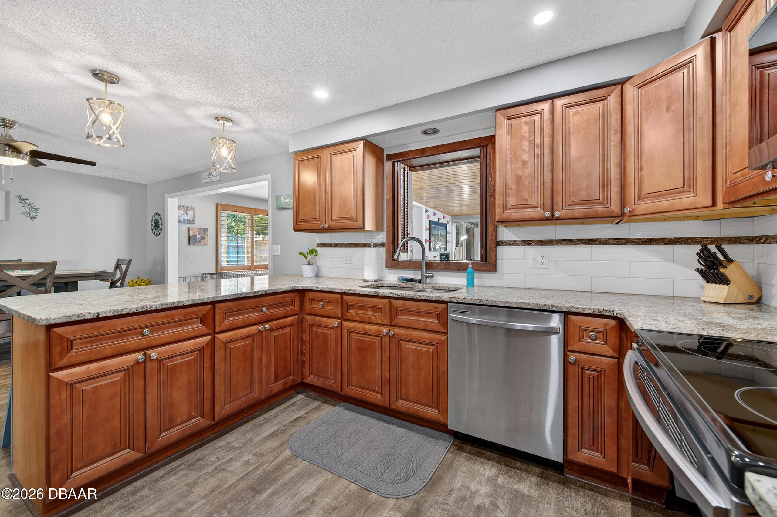 1010 Fernald Street Edgewater, FL 32132 - Photo 14 of 43 a kitchen with stainless steel appliances granite countertop a sink stove and cabinets