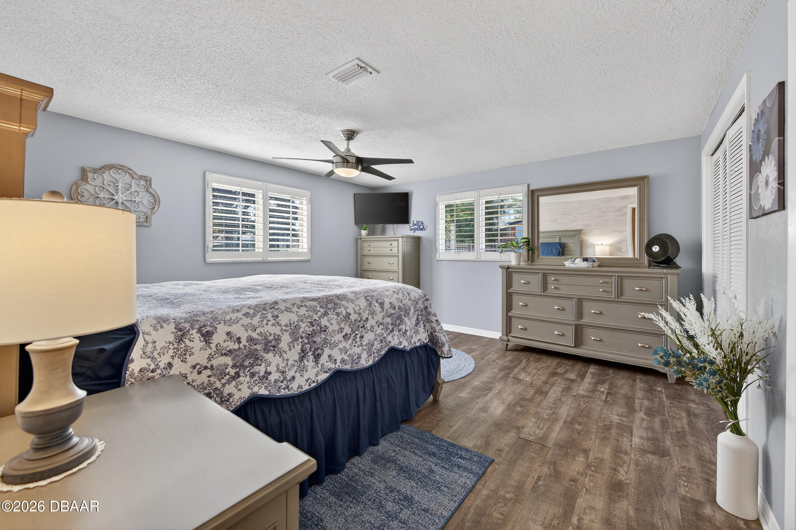 1010 Fernald Street Edgewater, FL 32132 - Photo 16 of 43 a bedroom with a bed and wooden floor