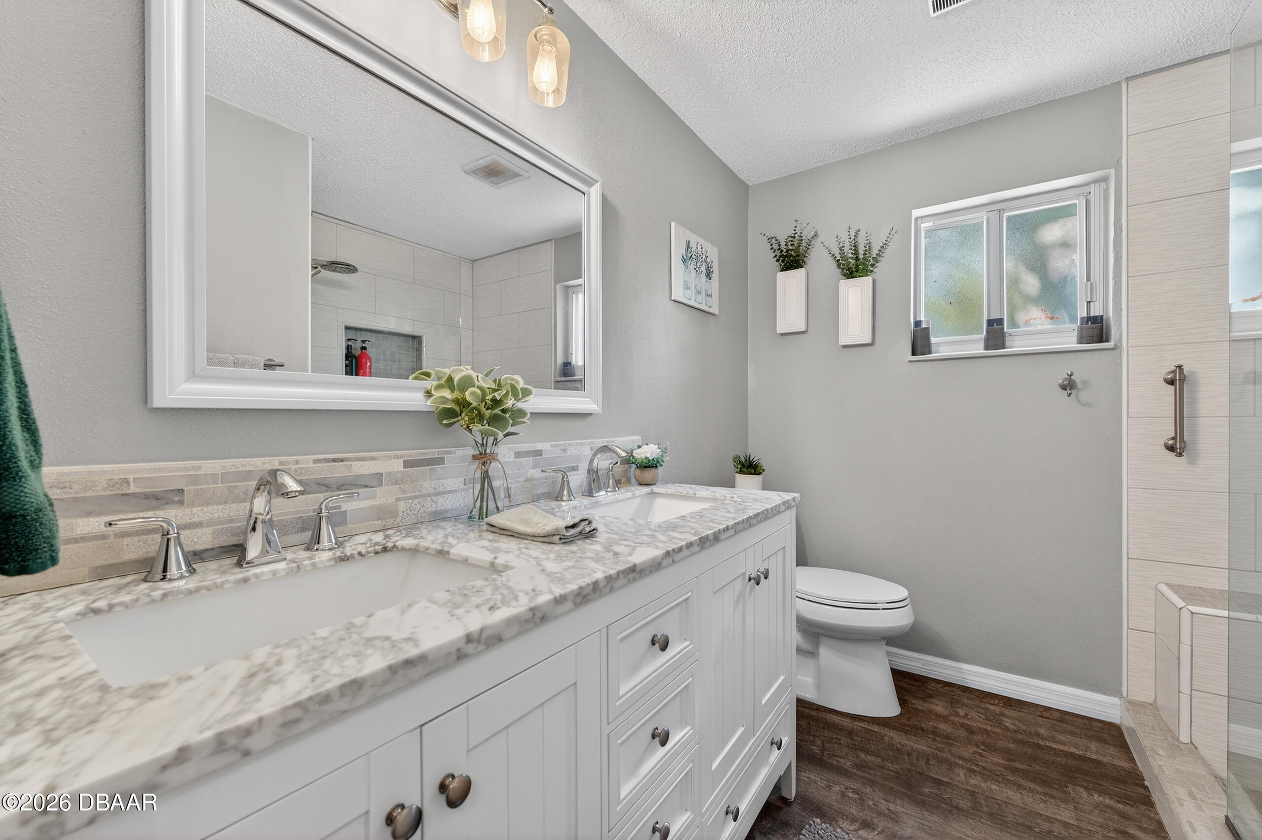 1010 Fernald Street Edgewater, FL 32132 - Photo 17 of 43 a bathroom with a granite countertop sink a toilet and mirror