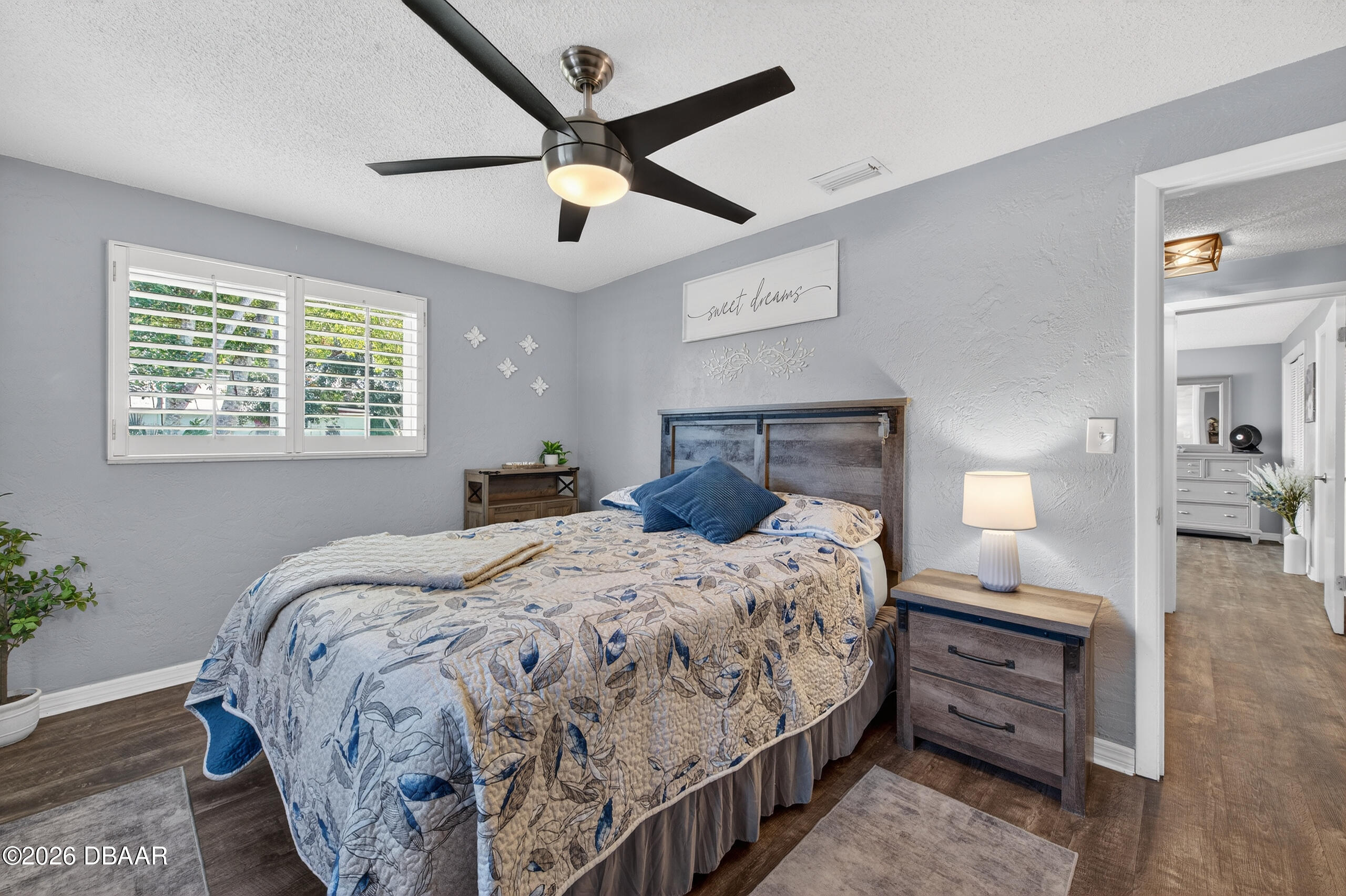 1010 Fernald Street Edgewater, FL 32132 - Photo 19 of 43 a bedroom with a bed and a chandelier