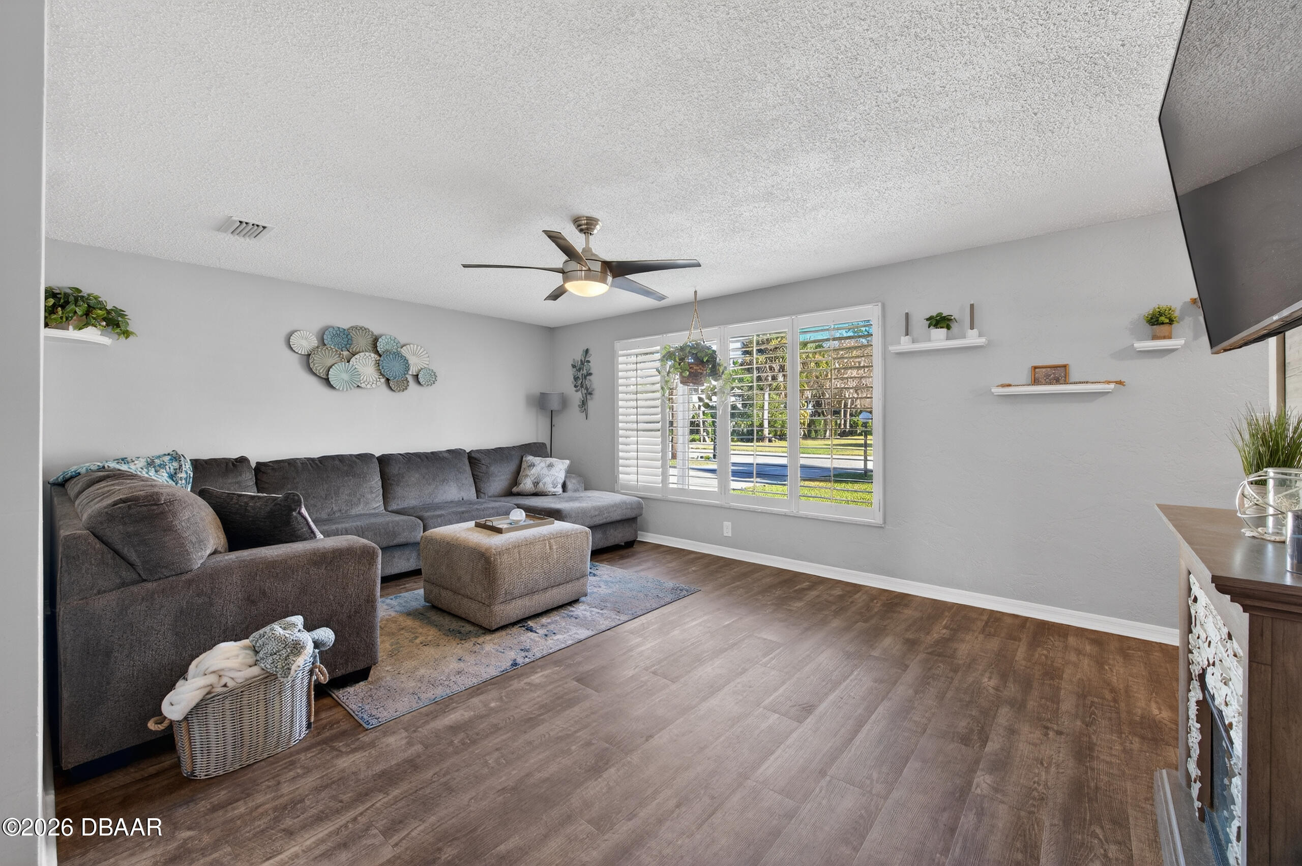 1010 Fernald Street Edgewater, FL 32132 - Photo 6 of 43 a living room with furniture and a flat screen tv