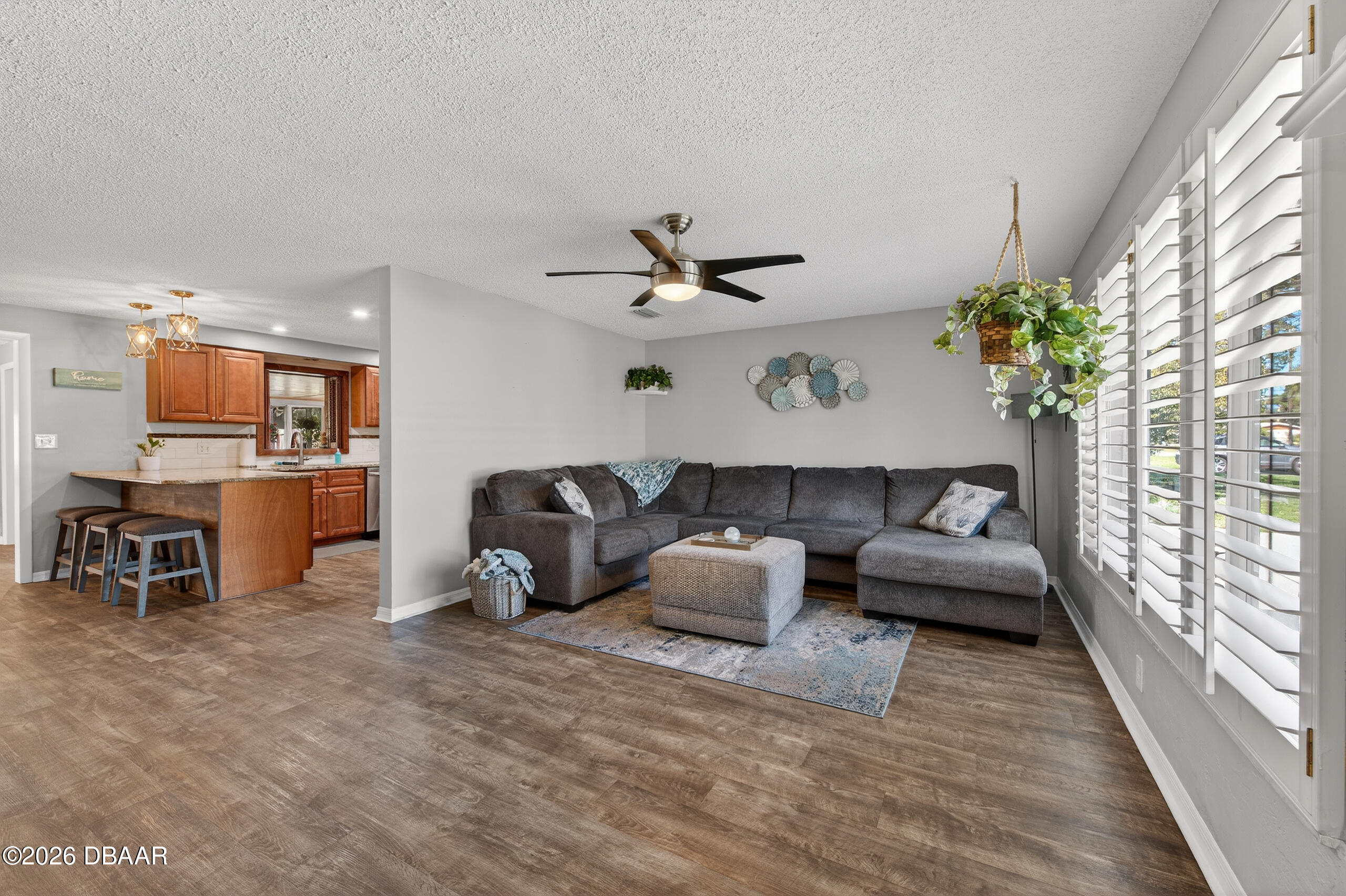 1010 Fernald Street Edgewater, FL 32132 - Photo 7 of 43 a living room with furniture floor to ceiling window and a flat screen tv