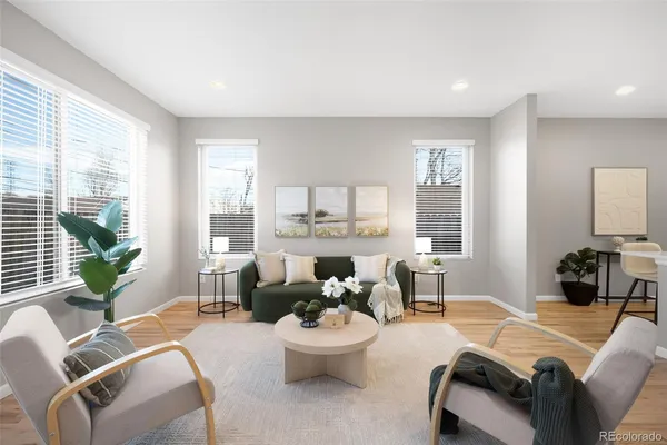 a living room with furniture and a dining table with kitchen
