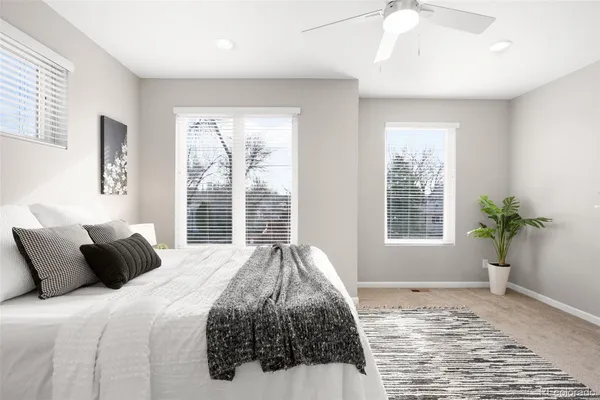 a bedroom with a large bed and chandelier