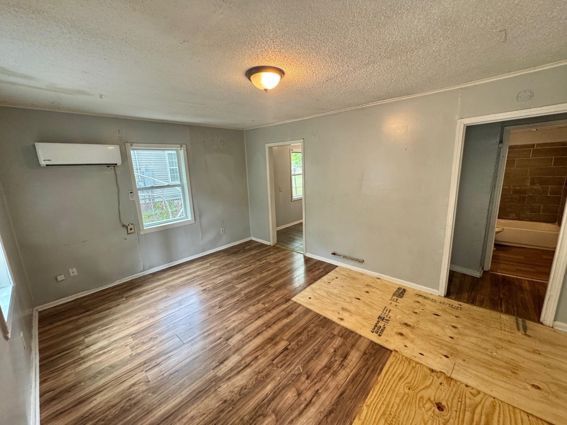 5299 Airview Road Memphis, TN 38109 - Photo 5 of 11 a bedroom with a bed and wooden floor