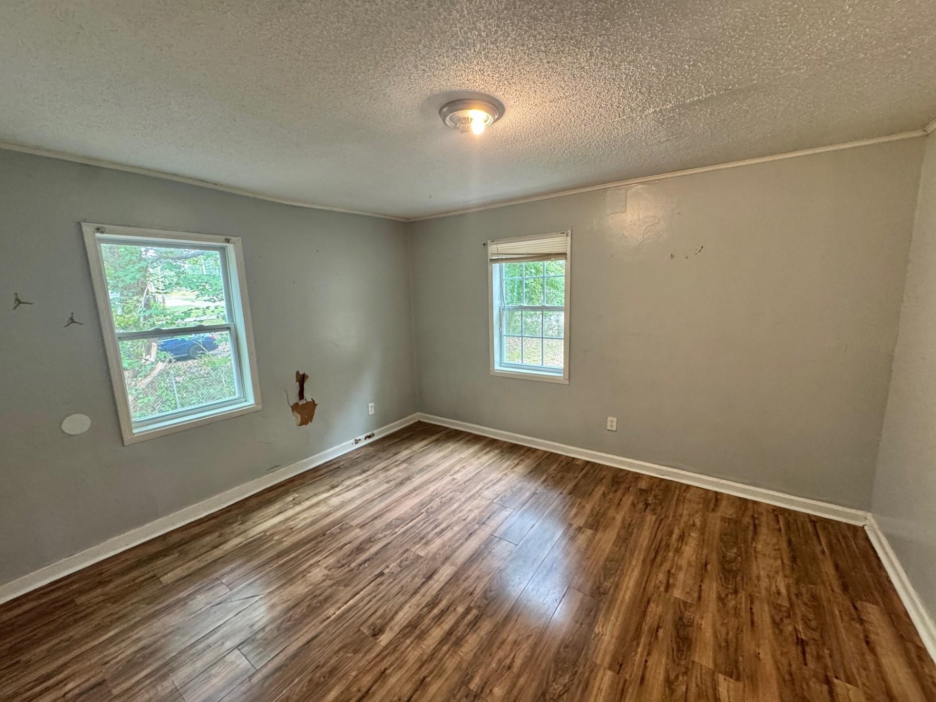 5299 Airview Road Memphis, TN 38109 - Photo 8 of 11 a view of an empty room with wooden floor and a window