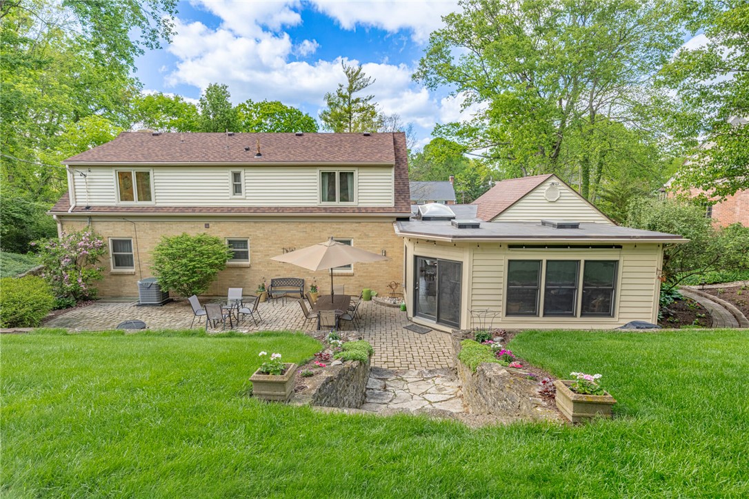 156 West Hadley Road Dayton, OH 45419 - Photo 49 of 71 This home features a lush green yard and an expansive outdoor patio, perfect for enjoying the outdoors.
