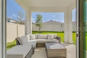 a living room with a couch and a dining table next to a window
