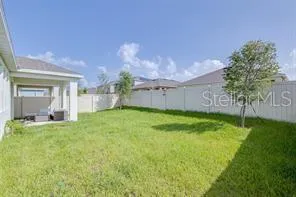 a backyard of a house with table and chairs