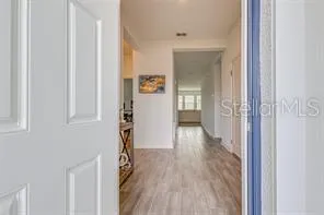 a view of hallway with wooden floor