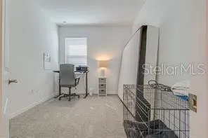 a view of a workspace with furniture and stairs