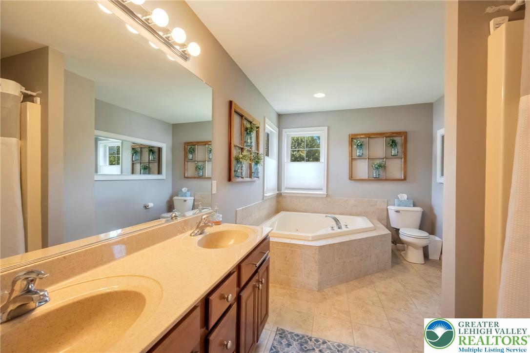 204 Bushkill Ridge Road Wind Gap, PA 18091 - Photo 28 of 48 Dual vanity sinks complement a soaking tub, offering a peaceful bathing experience.