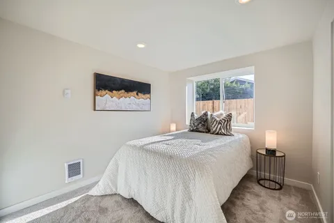 a bed room with a bed a lamp and a window