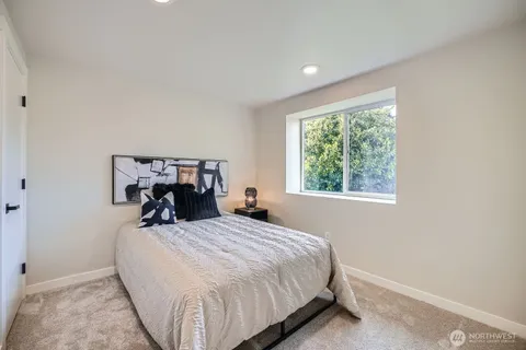 a bed sitting in a bedroom next to a window