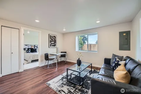 a living room with furniture or couch and a wooden floor