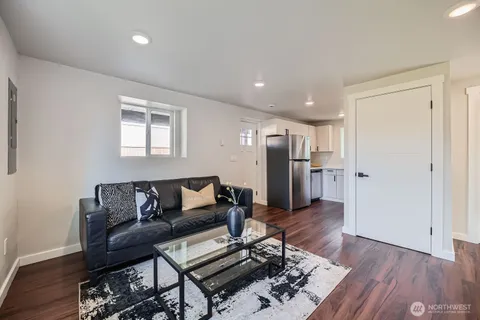 a living room with furniture and wooden floor