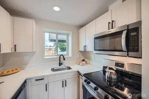 a kitchen with a sink stainless steel appliances and cabinets