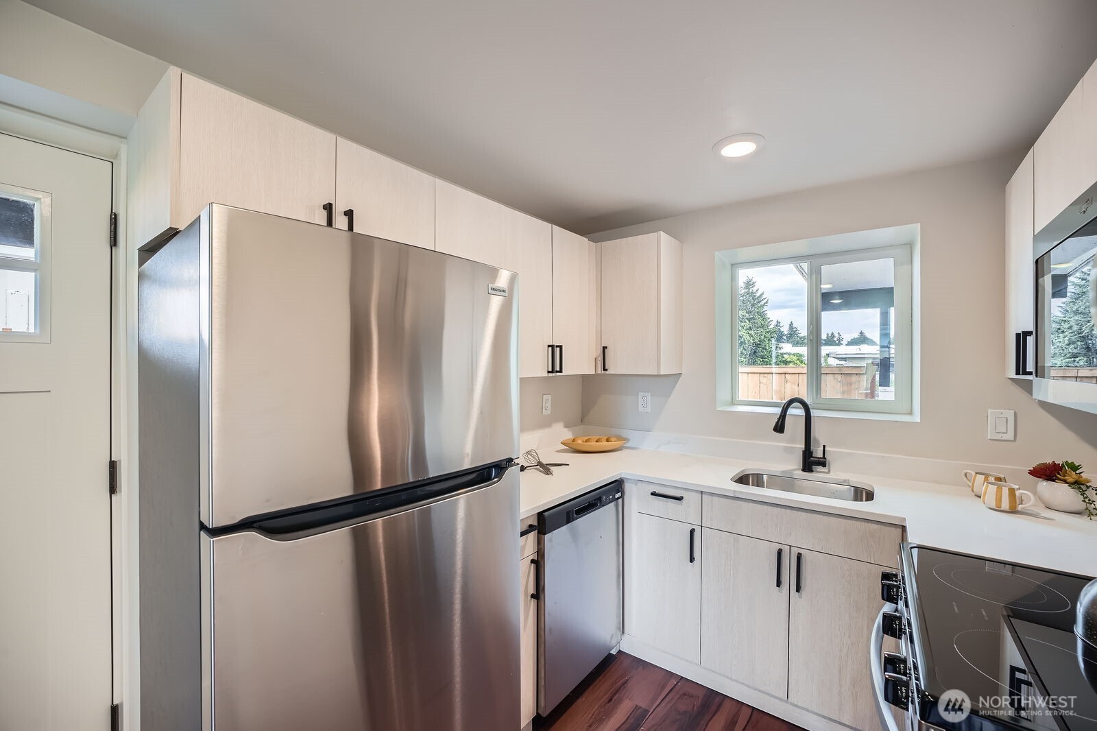 9206 33rd Ave Court South Lakewood, WA 98499 - Photo 9 of 21 a kitchen with a refrigerator sink and cabinets