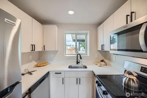 a kitchen with a sink stove and microwave