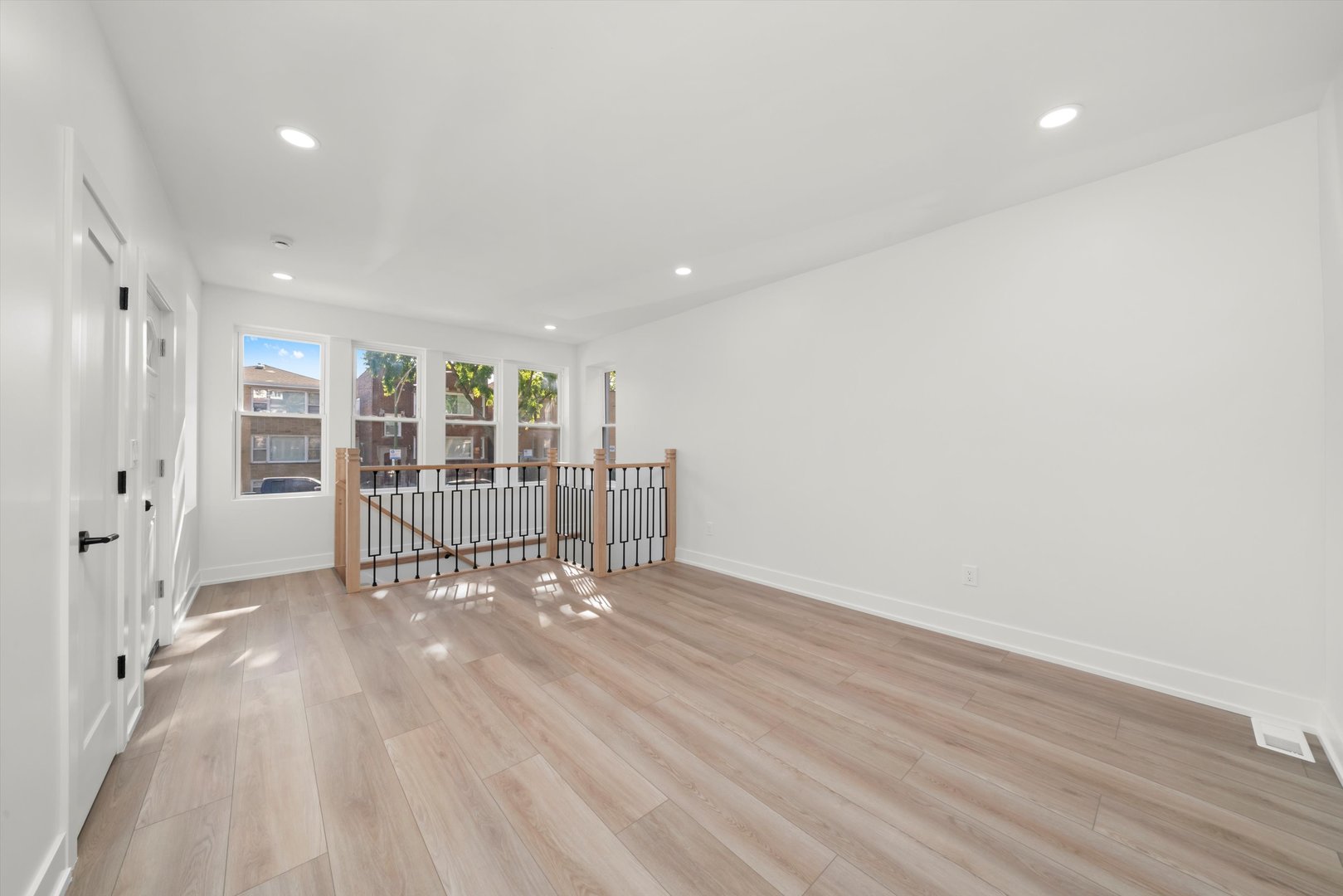 7150 South Talman Avenue, Unit 1 Chicago, IL 60629 - Photo 5 of 19 a view of an empty room with wooden floor and a window
