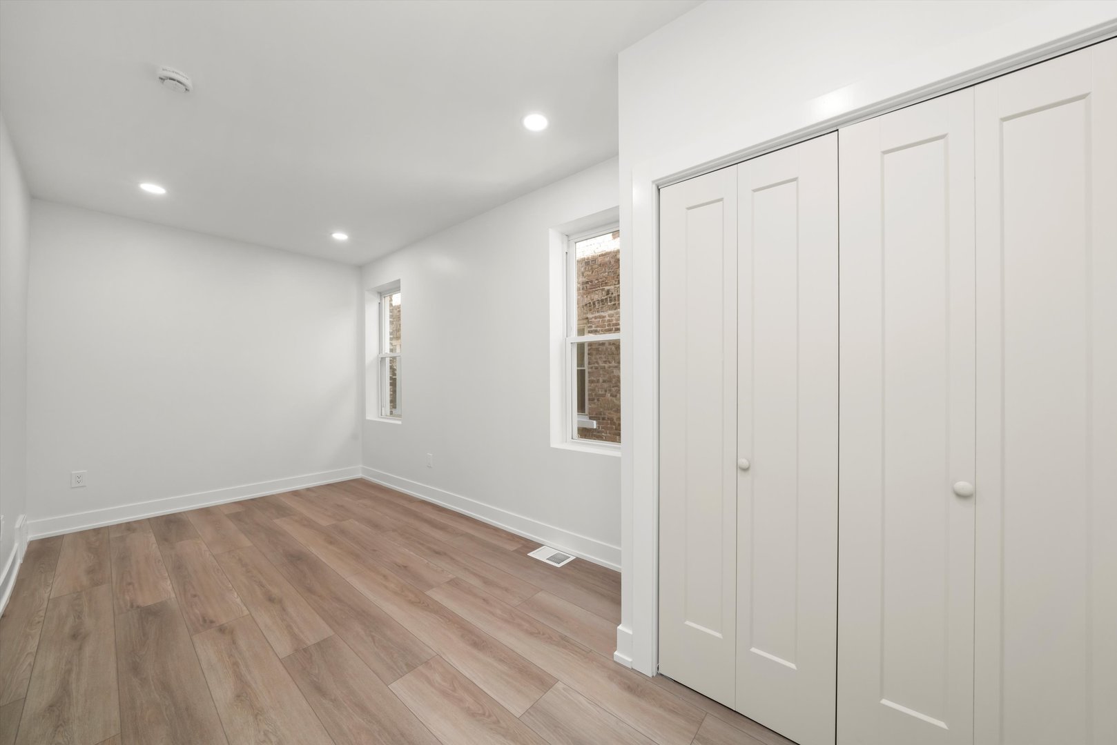7150 South Talman Avenue, Unit 1 Chicago, IL 60629 - Photo 6 of 19 a view of an empty room with wooden floor
