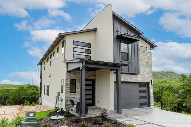 a front view of a house with garden
