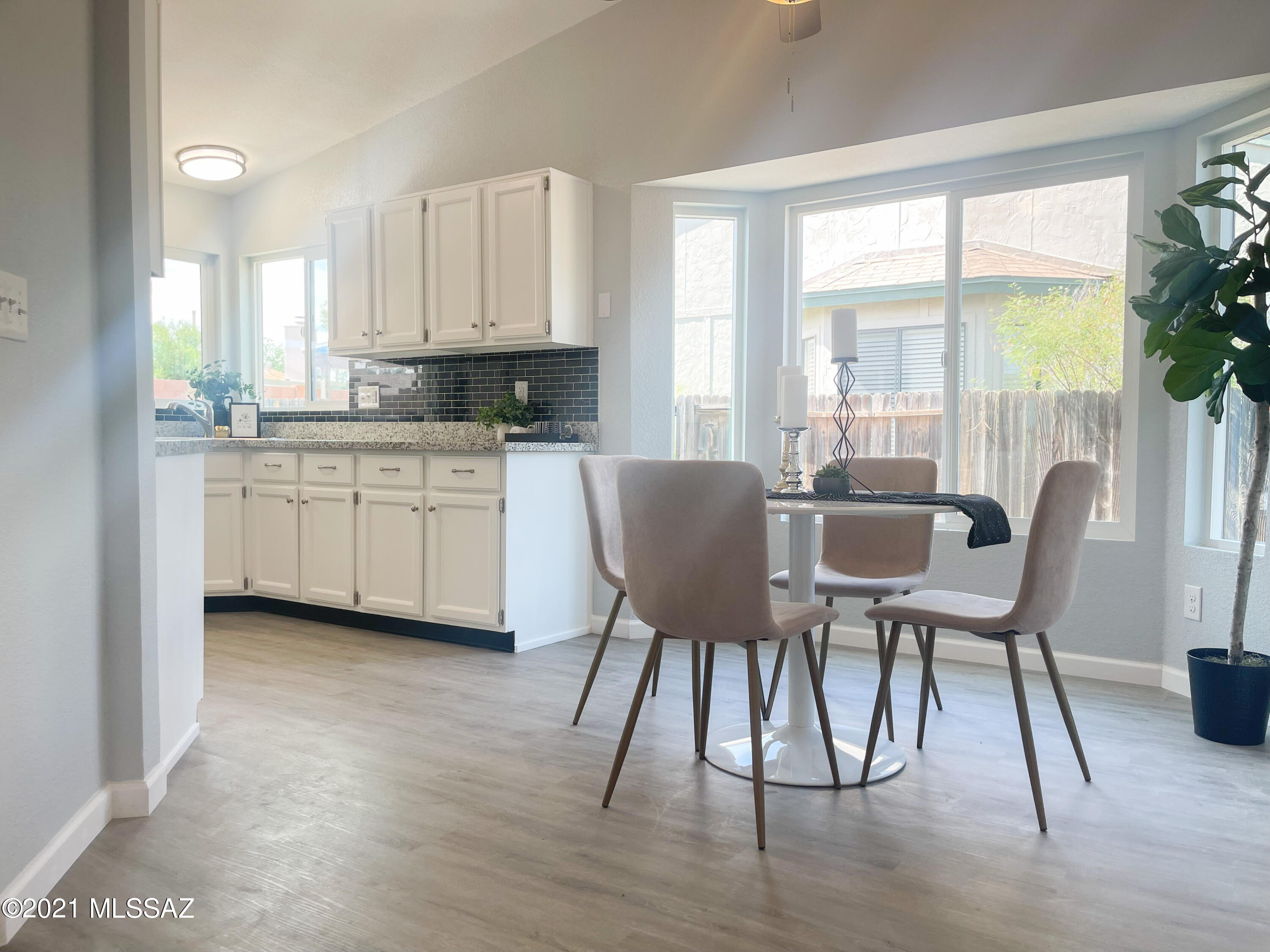 2611 West Sunset Road Tucson, AZ 85741 - Photo 6 of 20 a view of a dining room with furniture window and wooden floor