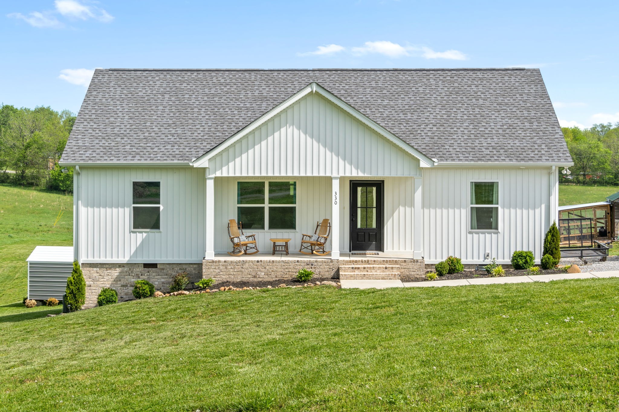 330 Woodruff Road Adams, TN 37010 - Photo 1 of 31 a front view of a house with a yard and garage