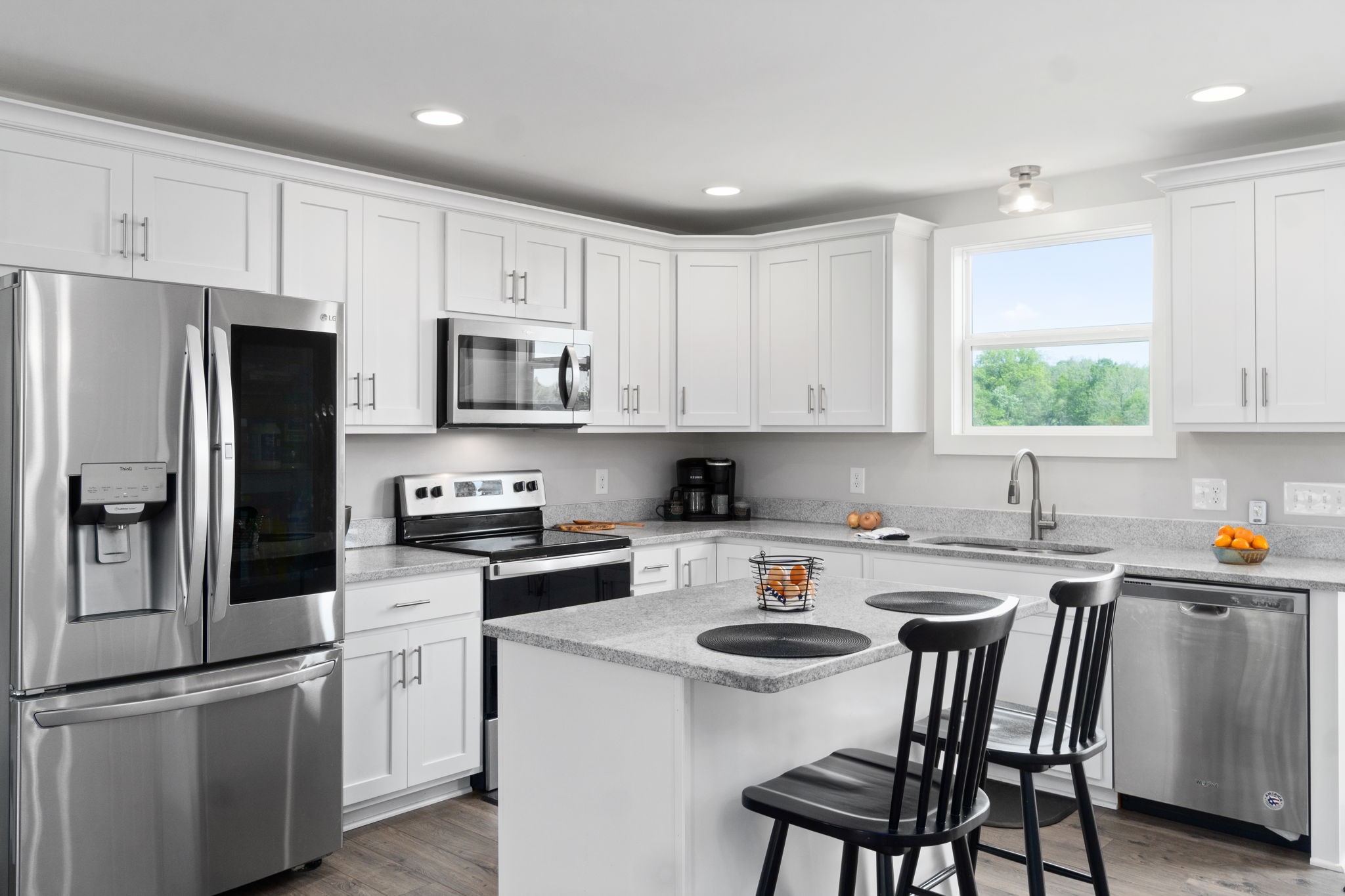 330 Woodruff Road Adams, TN 37010 - Photo 14 of 31 a kitchen with white cabinets and stainless steel appliances