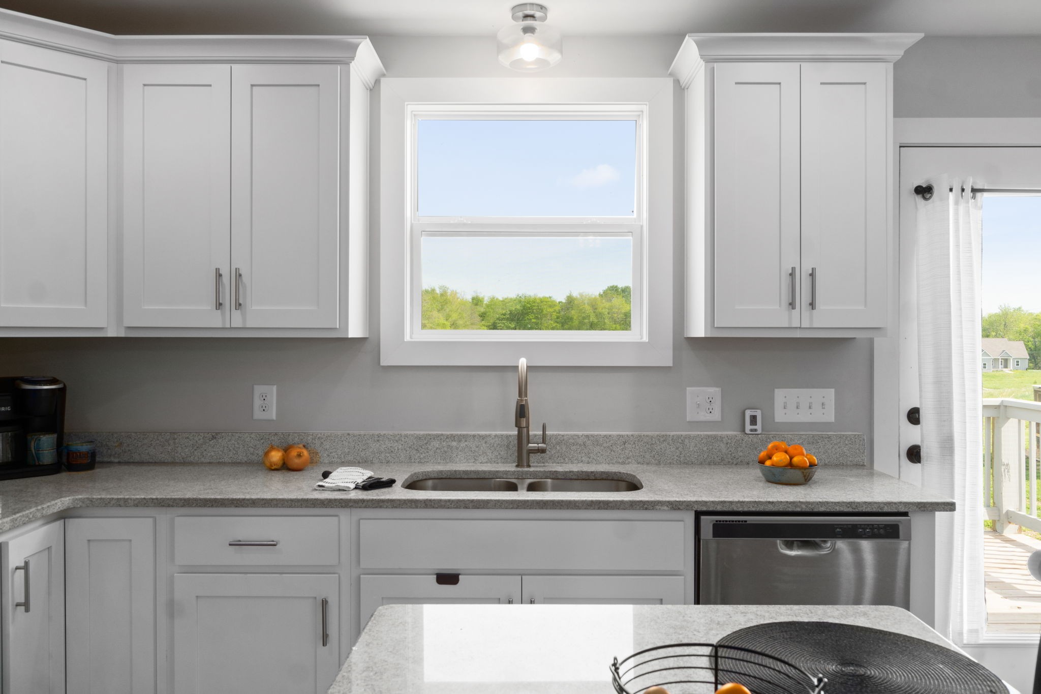 330 Woodruff Road Adams, TN 37010 - Photo 17 of 31 a kitchen with stainless steel appliances granite countertop white cabinets and window