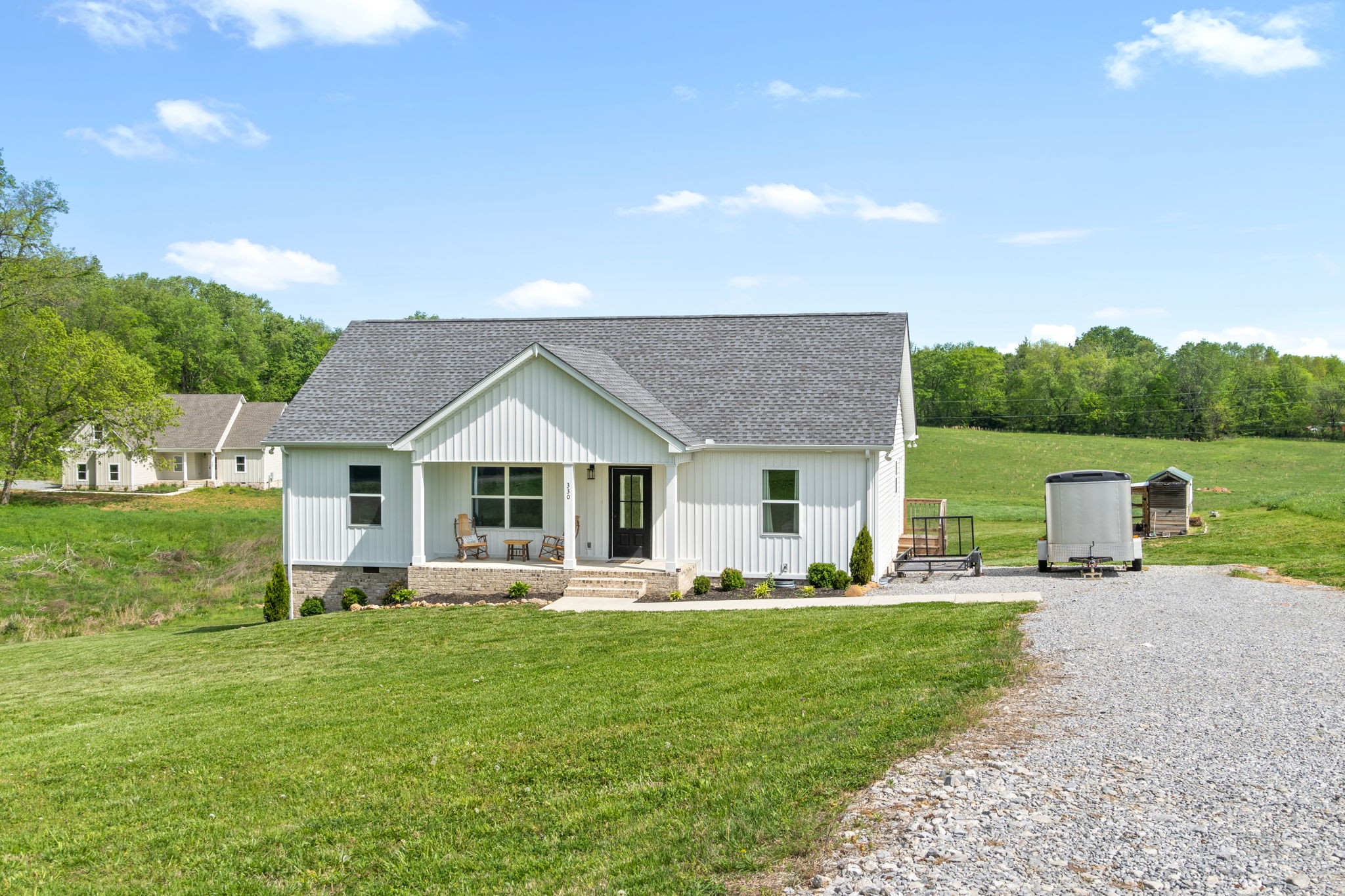 330 Woodruff Road Adams, TN 37010 - Photo 2 of 31 a front view of house with outdoor seating and green space