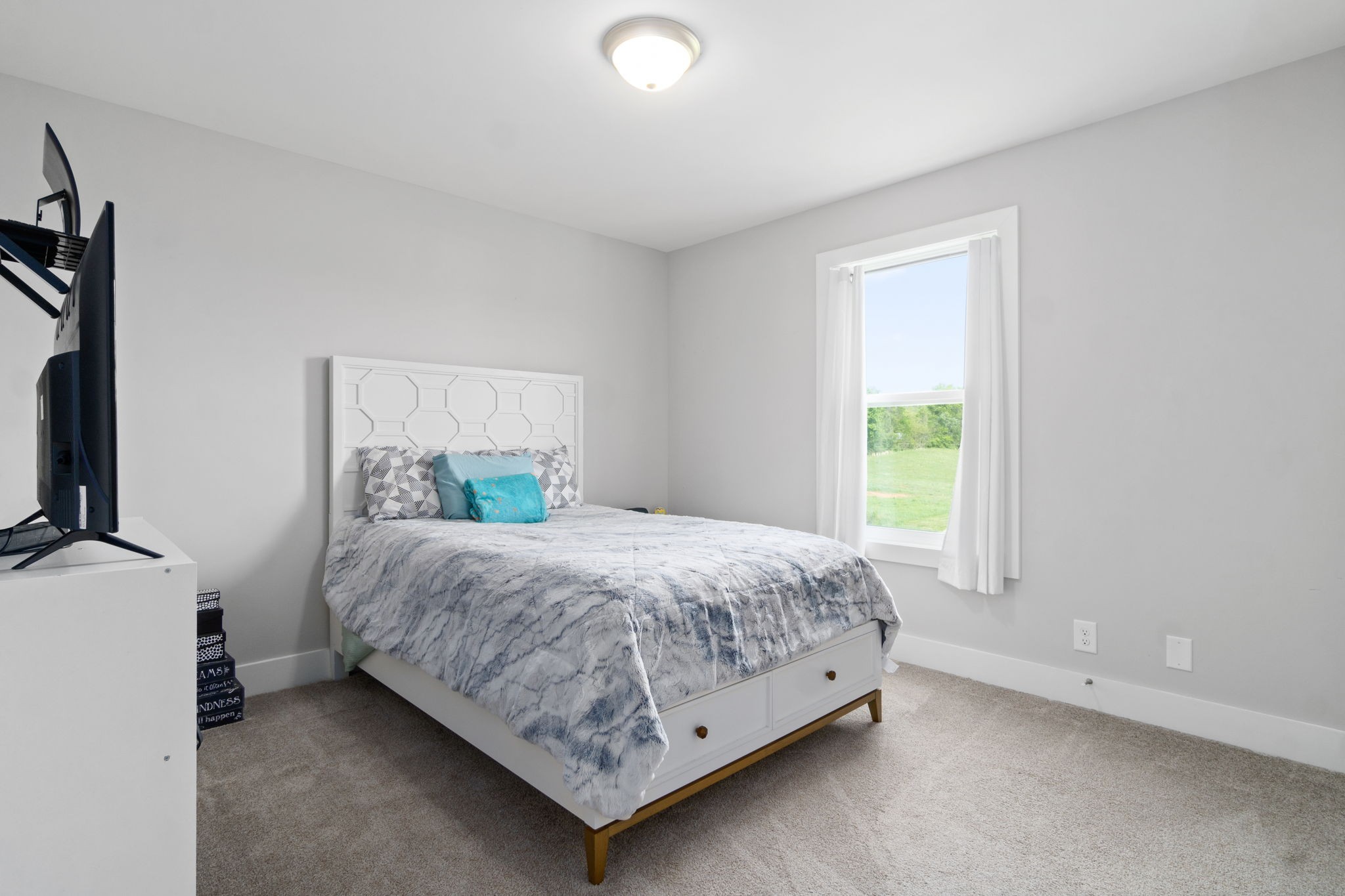 330 Woodruff Road Adams, TN 37010 - Photo 22 of 31 a bedroom with a bed and a flat tv screen on dresser