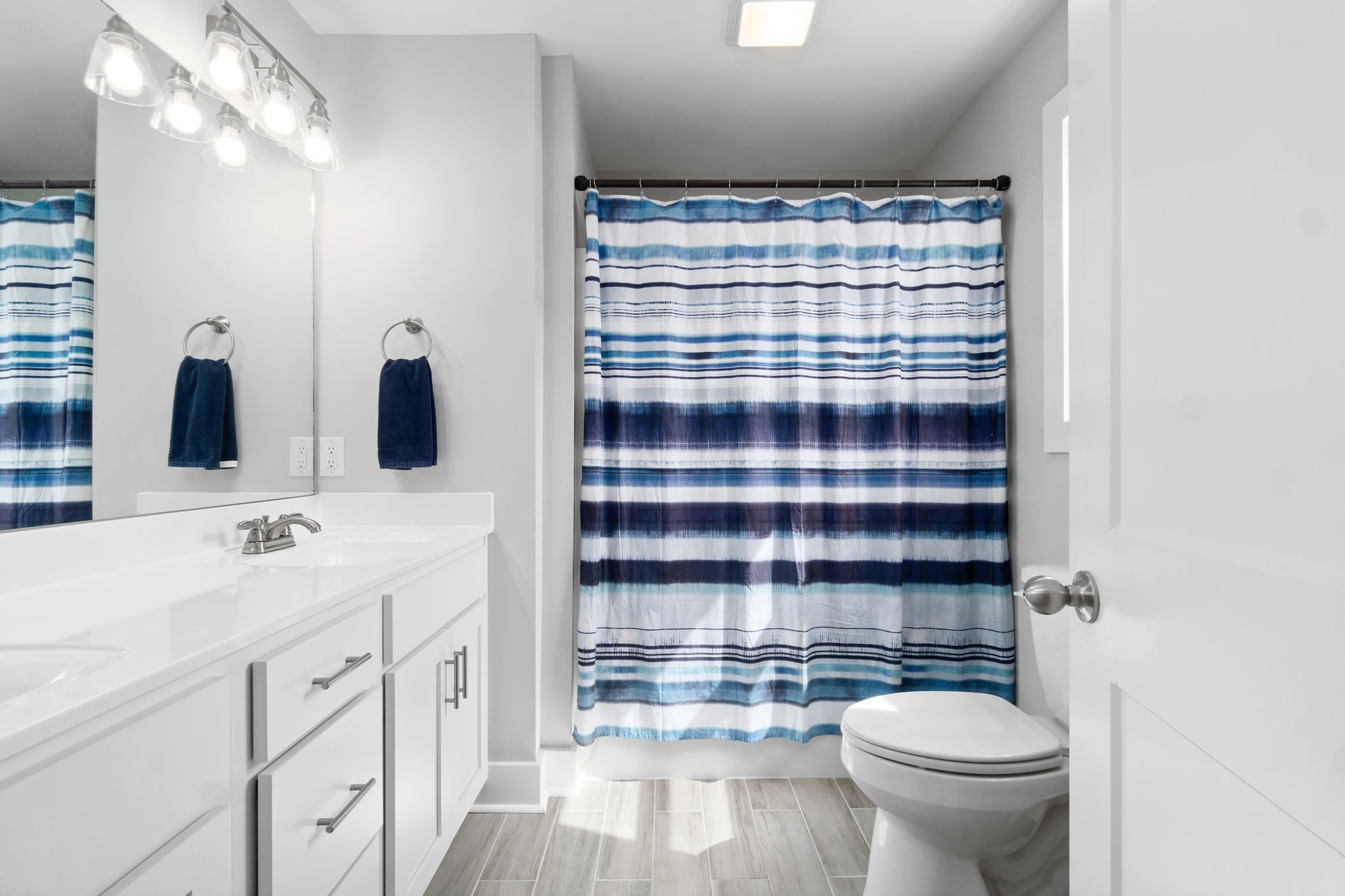 330 Woodruff Road Adams, TN 37010 - Photo 26 of 31 a bathroom with a sink a toilet and shower curtain