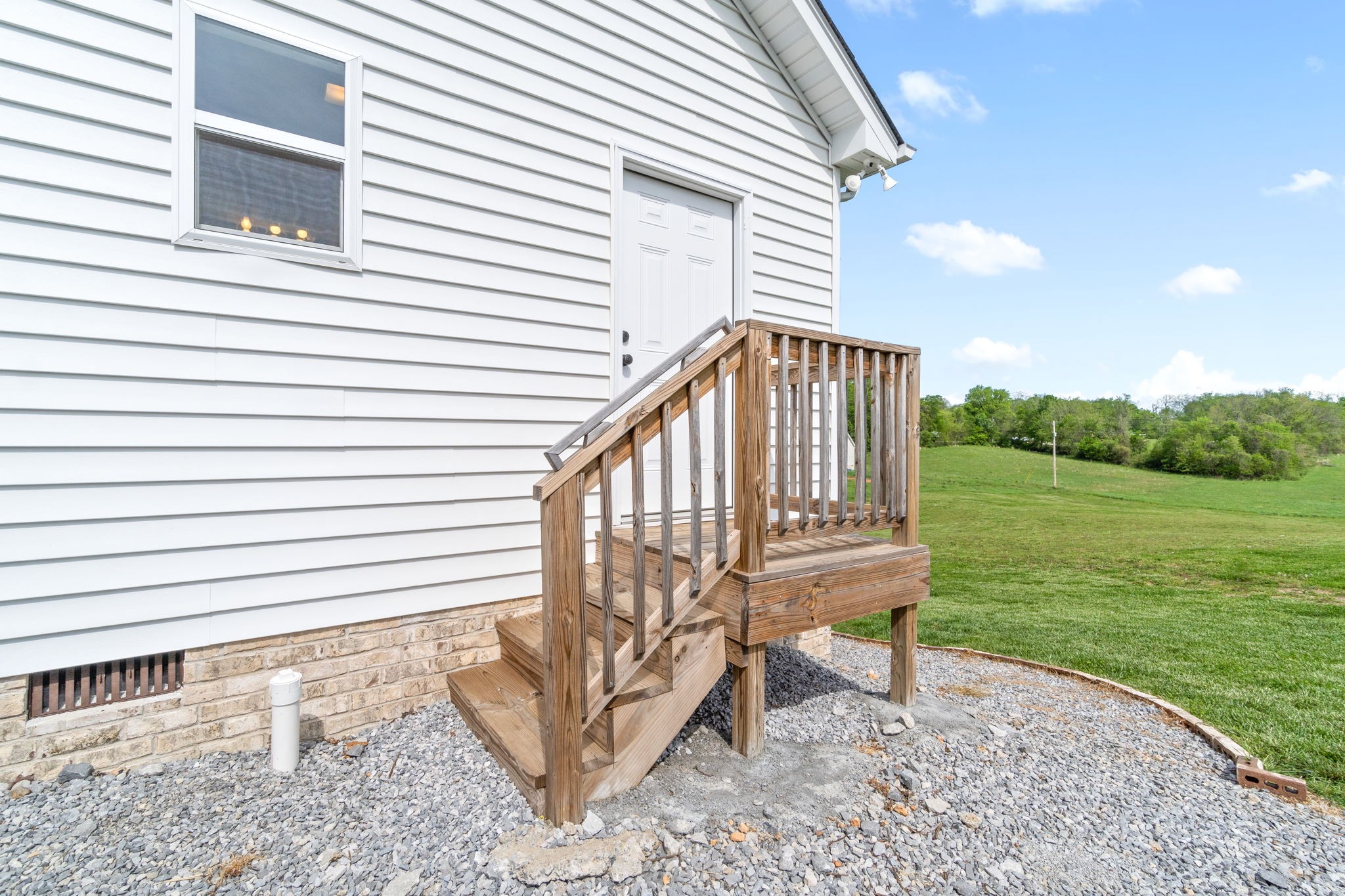 330 Woodruff Road Adams, TN 37010 - Photo 29 of 31 a view of a house with a yard and a wooden deck