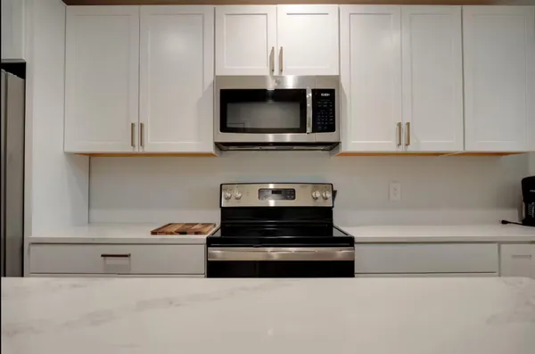 a kitchen with a stove and a microwave