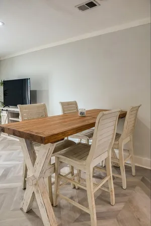 a view of a dining room with furniture and a flat screen tv